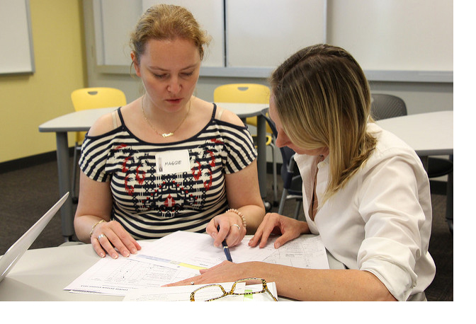 Two people looking at a document